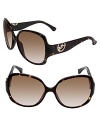 Show off your fashion sense in oversized sunglasses with metal logo charm at temples from MICHAEL Michael Kors.