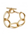 Add a little asymmetry to your style, from Kenneth Cole New York. Hammered circles of gold-plated mixed metal link together and close with a toggle. Approximate length: 7 inches.