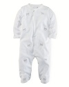 An adorable long-sleeved footed coverall crafted in soft cotton jersey is accented with schiffli embroidery.