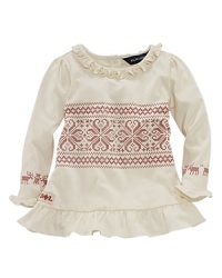 An adorable printed tunic with ruffle trim features a festive snowflake pattern.