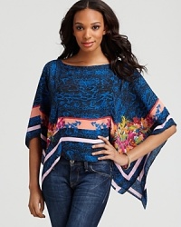 Inspired by the tropics, the eclectic print on this poncho-inspired BCBGMAXAZRIA top enlivens your look with vibrant color and energetic spirit. Slip it on with your denim skinnies for an instant rush of balmy style.