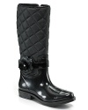 A black flower wraps the ankles of these quilted boots from Stuart Weitzman for rainy day chic.