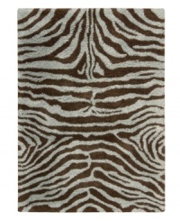 Exotic designs will be the pride of your decor. Adorned with zebra stripes in aqua blue and brown, this Nourison rug has a marvelously soft and shaggy pile that's hand-tufted from premium-quality yarns. Beautiful in appearance and plush underfoot, this area rug creates an atmosphere of casual elegance. (Clearance)