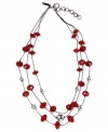 Paint the town red. This three-row necklace from Nine West is crafted from hematite-tone mixed metal with red glass and epoxy stones, as well as glass crystal fireballs, for a stylish effect. Approximate length: 16 inches + 2-inch extender. Approximate drop: 1-1/2 inches.