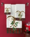 Delight and dazzle this season with the Lenox Holiday Nouveau fingertip towel, featuring a traditional holiday plaid and holly embellished with glittery gold accents.