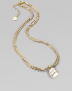 A single white baroque pearl hangs gracefully from delicate chains of 18k rose and yellow gold vermeil, and sterling silver. 16mm white organic man-made pearl Length, about 16 with 2 extender Lobster clasp Made in Spain