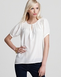 Elevate your favorite jeans with this little white top from Joie that's anything but basic.