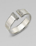 An elegantly ribbed, flexible cuff with Swarovski crystal caps.CrystalSilverplatedDiameter, about 2¼Made in Italy