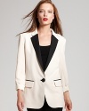 Top your looks with masculine edge with this Nanette Lepore tuxedo blazer, boasting classic detailing and a chic monochromatic palate.