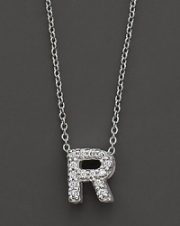 From the Tiny Treasures collection, a diamond R necklace. With signature ruby accent. Designed by Roberto Coin.