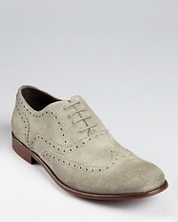 Classic brogue and perforation details bring out the suede's textured softness on these comfortable wingtips, an updated classic from John Varvatos USA.