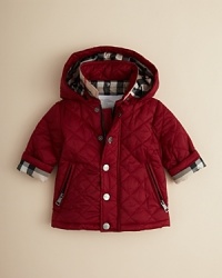 Burberry's beautifully-crafted quilted jacket brings warmth in both style and feeling to your little one's cold-weather wardrobe.