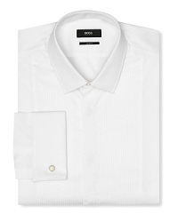 A slim fit tuxedo dress shirt with intricate pintuck detail in front. Covered placket except top button showing, tonal textured stripes. Small point collar. French cuffs.