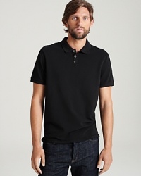 Short sleeve polo with two button placket with woven detail. Ribbed collar and cuffs.