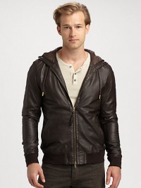 A rich leather jacket with a two-way zip front, is a definite wardrobe essential, while an attached hood lends a contemporary edge that is both rugged and refined.Two-way zip frontAttached drawstring hoodWaist slash pocketsBanded cuffs and hemAbout 26 from shoulder to hemLeatherDry cleanImported