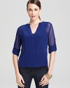 Work this woven BCBGMAXAZRIA top into your everyday wardrobe by pairing it with pants and skirts. It's chic, simplified.