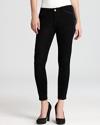 Black washed Paige Denim jeans in the sought-after ultra-skinny silhouette, enriched with contrast piping details for added flourish.