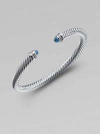 From the Color Classic Collection. A signature Yurman cable of sterling silver, richly enhanced by bands of pavé diamonds encircling blue topaz end caps. Diamonds, .09 tcw Blue topaz Sterling silver Width, 5mm Diameter, about 2½ Made in USA