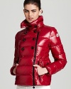 Moncler's lacquered Daim coat boasts a forward asymmetrical zip front and a decorative, double breasted silhouette.