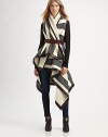 Pay homage to British tailoring in this blanket-inspired wrap coat with opposing stripe patterns, arm slits and buttery leather trim. Shawl collarArm slitsAsymmetrical hemFully linedAbout 44 from shoulder to hem at longest pointBody: 60% wool/33% polychloride/7% polyacetateTrim: LeatherDry clean with leather specialistMade in USA of Italian fabricThis style runs true to size. We recommend ordering your usual size for a standard fit. 