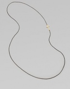 A simple oxidized sterling silver chain with a 14k gold cross, attached sideways for a modern look. 14k goldOxidized sterling silverLength, about 26Slip-on style Made in USA 