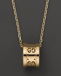 Gucci's iconic Gs circle a gleaming pendant of 18K yellow gold.