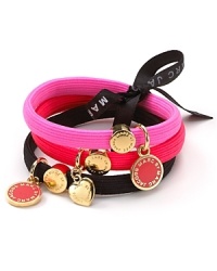 Do a 'do using this vibrant trio of hair elastics, adorned with MARC BY MARC JACOBS metal logo charms.