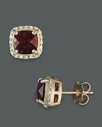 Diamonds frame faceted garnet, set in 14K yellow gold.