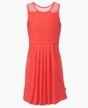 Hot style with a cool design, sheer mesh overlays on the shoulders of this DKNY dress add a unique twist.