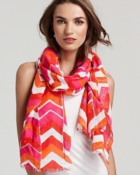 A lightweight chevron printed scarf with self fringe edges and a flashy color palette.