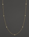 Diamond stations punctuate a long, elegant 18K yellow gold chain. By Roberto Coin.