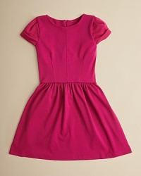 With a contoured bodice, cute cuffed sleeves and a ruffle skirt, this adorable dress looks great at parties and at play.