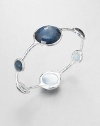 From the Wonderland Collection. Round faceted indigo doublet stations in various sizes set on a hammered sterling silver bangle. Indigo doubletSterling silverDiameter, about 2.5Slip-on styleImported 