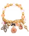 An amalgamation of charms. Betsey Johnson's bracelet highlights pink faceted beads with a half-stretch chain. Bracelet is decorated with a ombre-colored pave crystal rose, crystal leaves, a pink teardrop crystal, gold-tone bubble hearts, and pink faceted beads. Set in gold tone mixed metal. Approximate length: 7-1/2 inches.