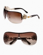 From the Mediterranean Flower Collection. These limited edition frames feature a gentle shield shape with brilliant, crystal accented flower temples. Available in silver/black with grey gradient lens or pale gold/dark brown with brown gradient lens. Crystal accented, flower logo temples100% UV protectionMade in Italy 