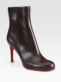 Shapely leather bootie with back seam detail and sculpted stiletto.Self-covered heel, 3½ (90mm) Shaft, 5¼ Leg circumference, 9½ Round toe Inside zip Leather lining Padded insole Signature red leather sole Made in ItalyOUR FIT MODEL RECOMMENDS ordering one half size up as this style runs small. 