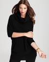 Approach your layers with luxe style sense in a sumptuous DKNY sweater with a statement cowl neckline.