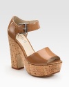 Natural cork heel and platform uplift a supple patent leather upper with an adjustable ankle strap. Cork heel, 5 (125mm)Cork platform, 1½ (40mm)Compares to a 3½ heel (90mm)Patent leather upperLeather lining and solePadded insoleImported