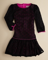 Sweetly dramatic, this drop-waist dress layers dark lace over a hot-pink underlay and finishes it with hot-pink piping.