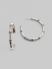 From the Nusa Penida Collection. Simple bamboo-shaped hoops crafted of fine sterling silver. This design was expressly created to support an afforestation project on Nusa Penida, an arid island off the coast of Bali. John Hardy will donate a portion of each purchase to the cost of planting bamboo. This earring will support the planting of 9 bamboos, which is inscribed inside the earring. Sterling silver Diameter, about 1¼ Post back Made in Bali