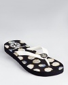 Curious hedgehogs roam across a printed pair of Tory Burch flip flops.