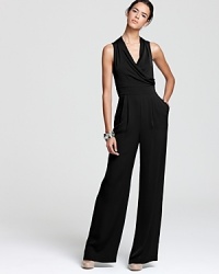 This elegant Catherine Malandrino jumpsuit flaunts pristine tailoring and the season's high-waisted silhouette. The perfect mix of modern and masculine, this piece ensures you make a sophisticated statement.