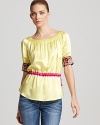 Bead and pearl embellished cuffs lend an opulent flair to this jewel-tone top from Aysha Collection.