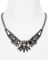 Silver gets a serious rock-chic edge on this Juicy Couture bib necklace, accented by a dramatic cluster of black and hematite colored stones.