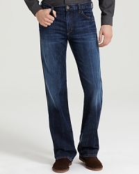 Low-waist, five-pocket bootcut jeans with zip fly. Deep blue wash with no fading, no distress. Features whiskering at the crotch and back of knee.