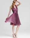 In a deep, floral hue, Halston Heritage's romantic halter dress lends a delicate look with intricate pleating.