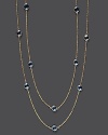 Round checkerboard blue topaz stations gleam on a long, loopable 14K yellow gold chain.