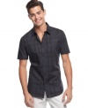 A fail-safe bet for your summer look is this dark plaid short-sleeved shirt from Calvin Klein.