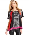 A graphic print with bright blocks of color gives this Vince Camuto top stop-them-in-their-tracks style. Wear with dark denim or go for all out glam with faux-leather leggings.