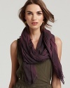 A large dyed woven scarf in a lightweight fabric with self fringe edges.